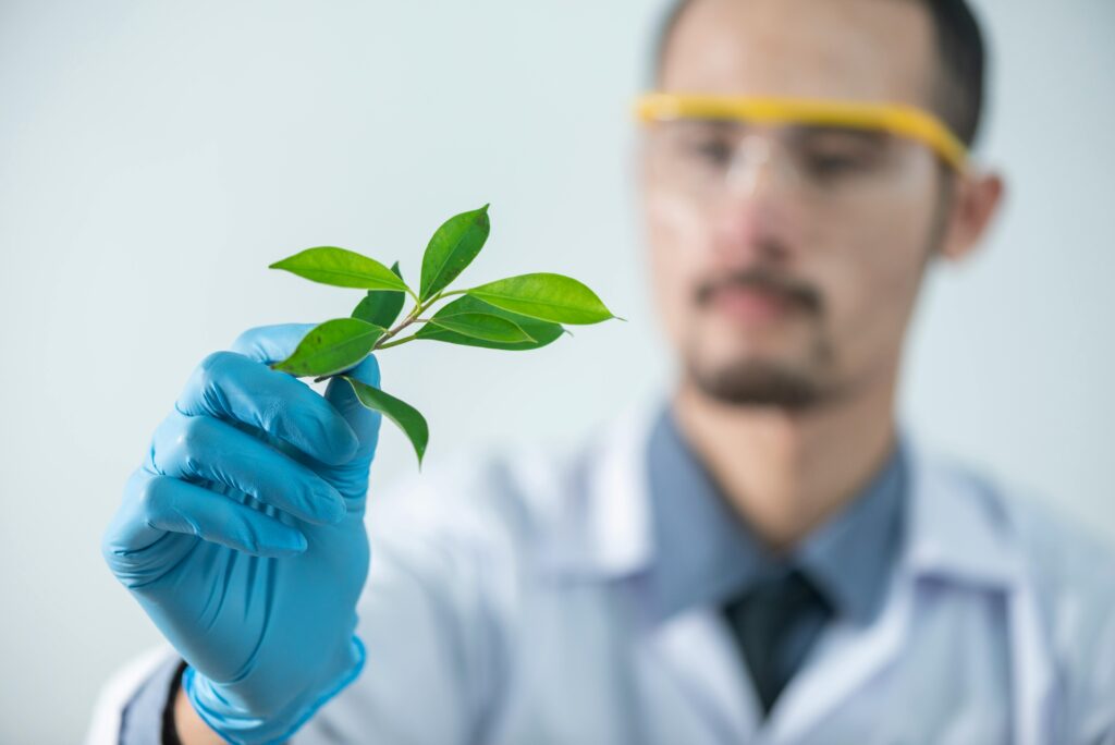pexels-photo-2280551-2280551 Young scientist wearing protective gloves and examining a plant sample in a laboratory setting.