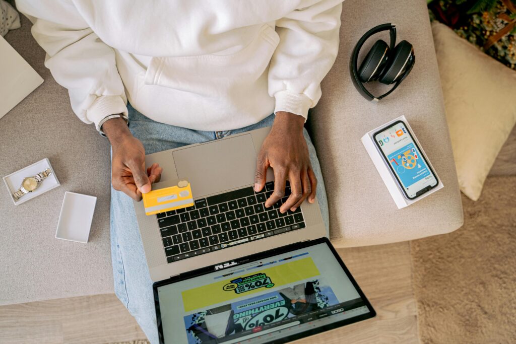 pexels-photo-6207767-6207767 Person shopping online with a credit card on a laptop, emphasizing convenience and technology.