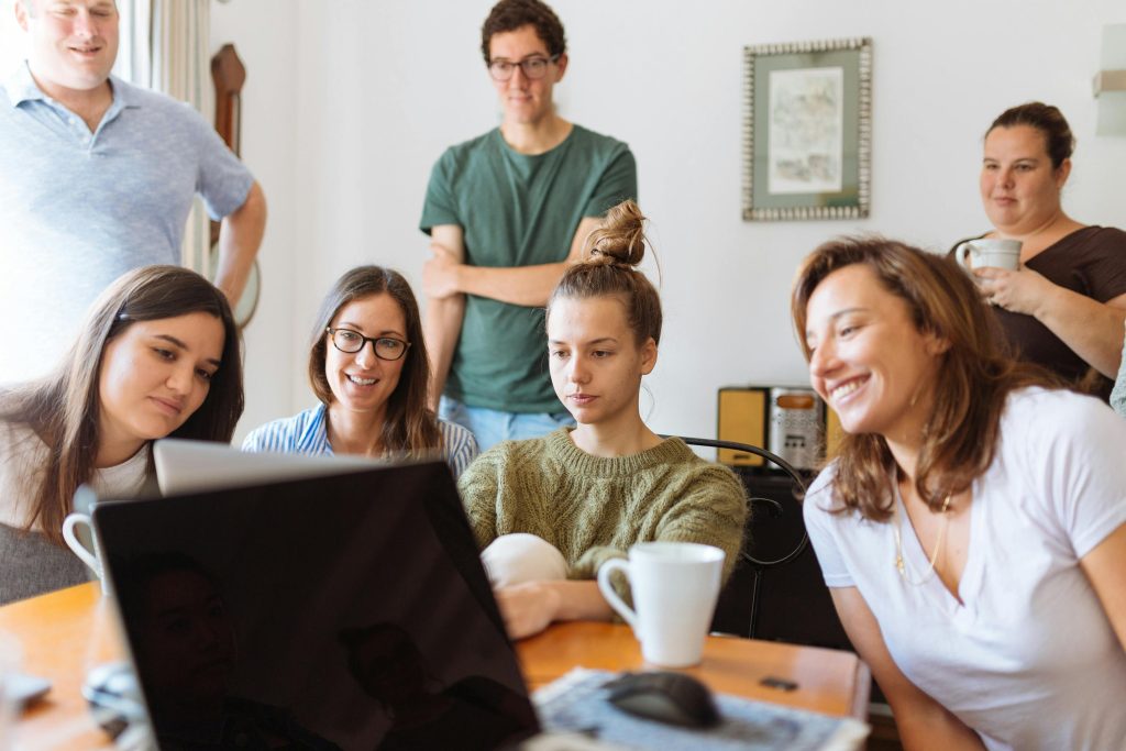 Group of people reviewing survey information together on a laptop