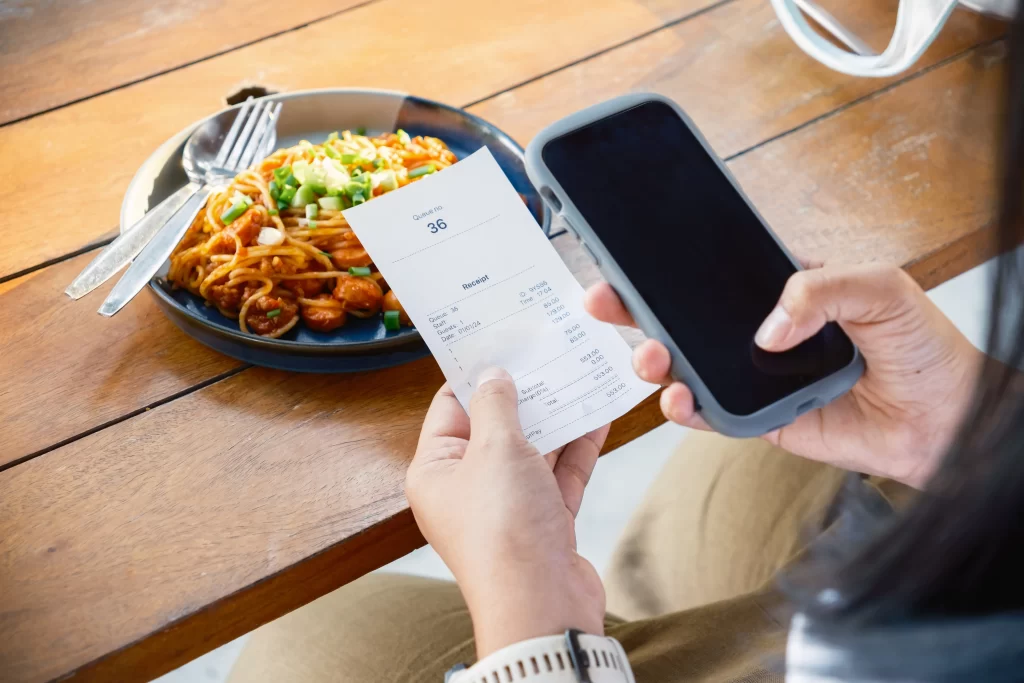 User scanning a shopping receipt with a mobile app to earn rewards