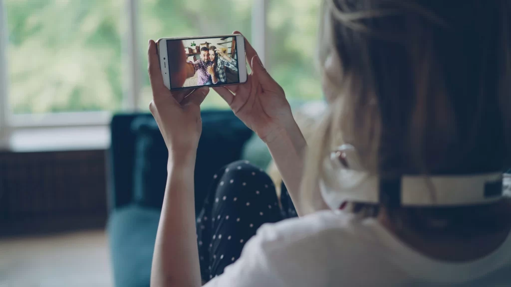Person watching videos on a smartphone as part of a rewards or survey app experience