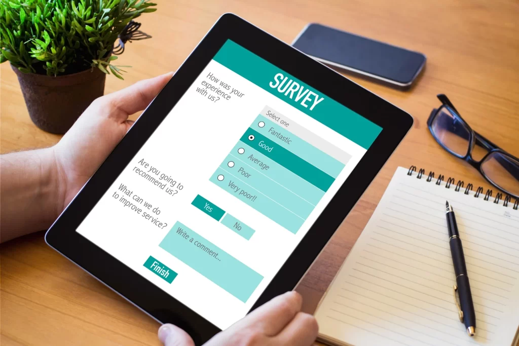 Person completing an online survey on a tablet, demonstrating how paid surveys work